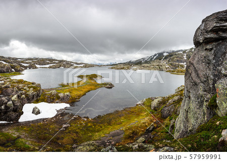 Amazing norwegian landscape with snowy mountains 57959991