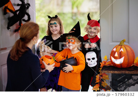 Kids trick or treat. Halloween. Child at door. 57960332