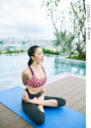 Relaxed woman exercising outdoors 57960527