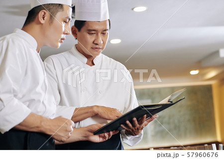 Asian chefs working with menu 57960676