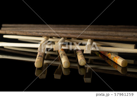 Asian chopsticks isolated on black glass Asian chopsticks isolated on black glass 57961259