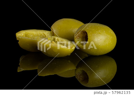 Pitted green olive isolated on black glass 57962135
