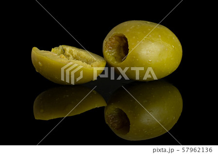 Pitted green olive isolated on black glass 57962136