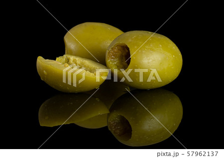 Pitted green olive isolated on black glass 57962137