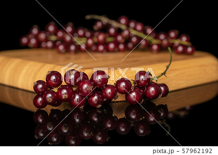 Fresh dark redcurrant isolated on black glass 57962192