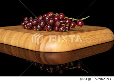 Fresh dark redcurrant isolated on black glass Fresh dark redcurrant isolated on black glass 57962193