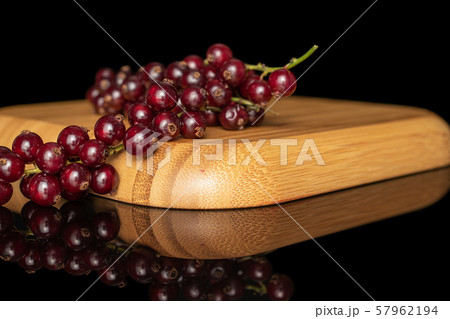 Fresh dark redcurrant isolated on black glass Fresh dark redcurrant isolated on black glass 57962194