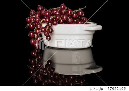 Fresh dark redcurrant isolated on black glass 57962196