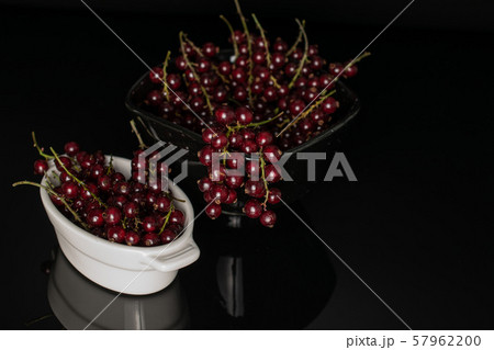 Fresh dark redcurrant isolated on black glass 57962200