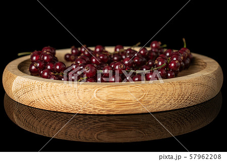 Fresh dark redcurrant isolated on black glass 57962208