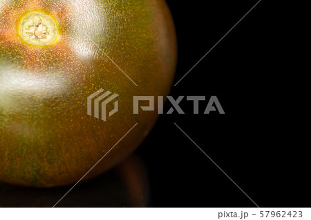 Fresh green red tomato isolated on black glass Fresh green red tomato isolated on black glass 57962423