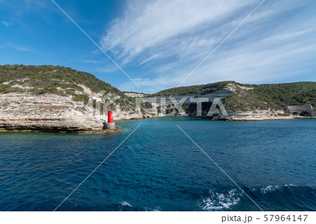 View from the yacht to the lighthouse, rocks. Blue sky with small clouds 57964147