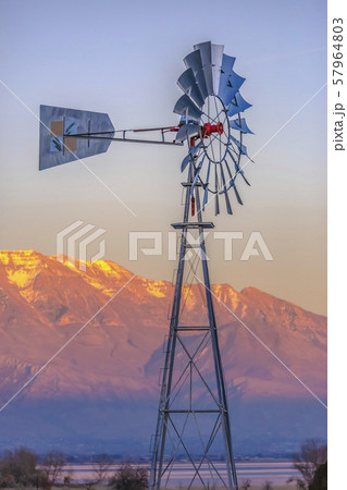 Windmill sits in front of Utah Lake and Timpanogos 57964803