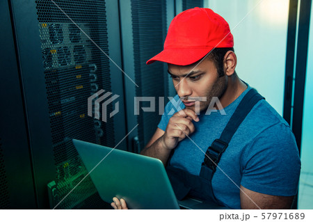 Serious thoughtful man looking at the laptop screen 57971689
