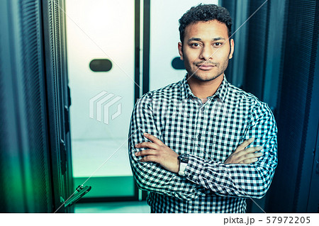 Smart intelligent man standing in the server room 57972205