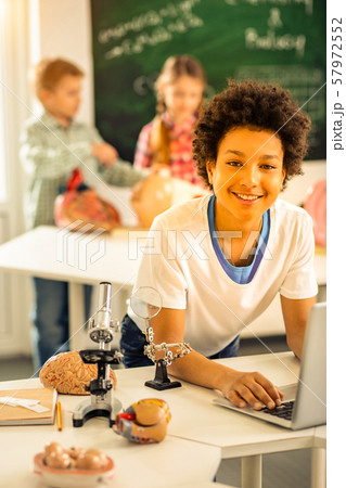 Handsome international pupil looking straight on camera Handsome international pupil looking straight on camera 57972552