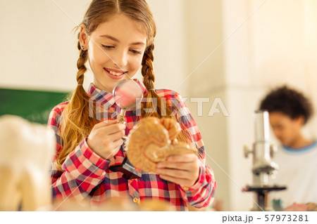 Portrait of happy little female that learning anatomy 57973281