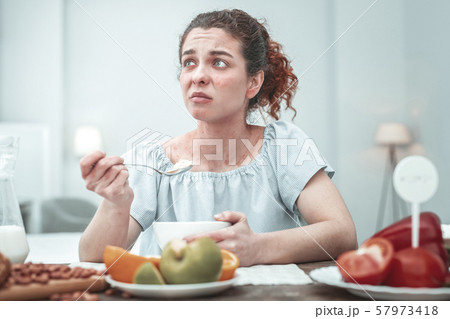 Curly woman with skin rash having allergy to some food 57973418