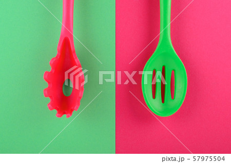 bright kitchen utensils on red and green background, creative idea bright kitchen utensils on red and green background, creative idea 57975504