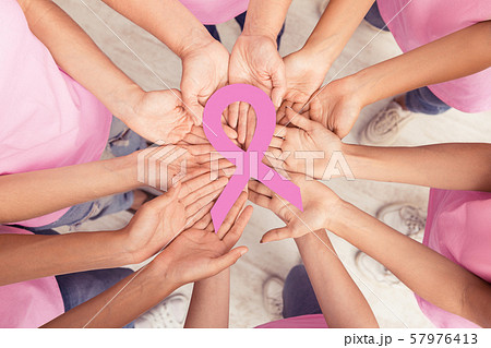 Women Hands Holding Pink Breast Cancer Ribbon Standing Together Women Hands Holding Pink Breast Cancer Ribbon Standing Together 57976413