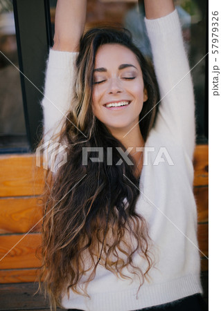 Young beautiful happy woman with long curly hair Young beautiful happy woman with long curly hair 57979326