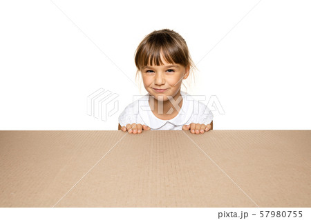 Cute little girl opening the biggest postal package 57980755