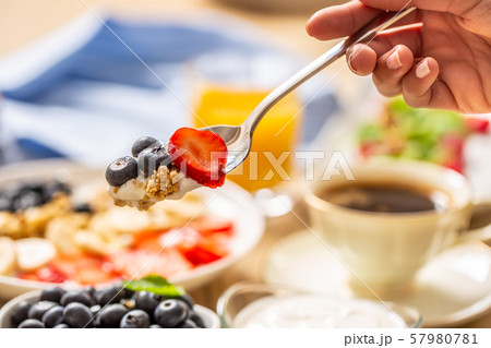 Healthy breakfast on spoon muesli blueberry yogurt Healthy breakfast on spoon muesli blueberry yogurt 57980781