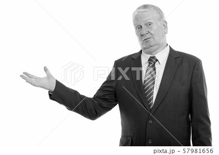 Studio shot of mature businessman showing something 57981656