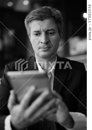 Businessman relaxing at the coffee shop in Bangkok, Thailand Businessman relaxing at the coffee shop in Bangkok, Thailand 57982038