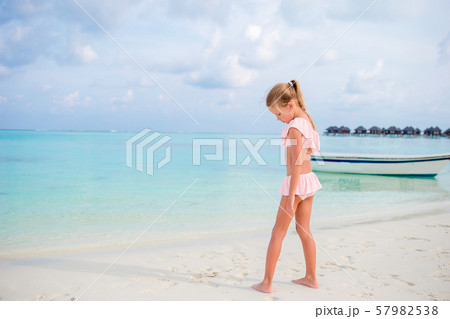 Adorable little girl during beach vacation having fun 57982538