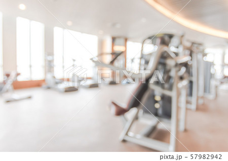 Blur gym background fitness center or health club with blurry sports exercise equipment for aerobic workout and bodybuilding Blur gym background fitness center or health club with blurry sports exercise equipment for aerobic workout and bodybuilding 57982942