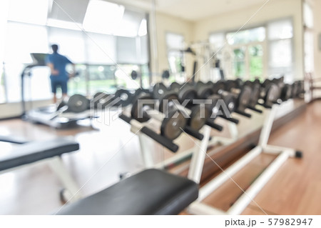 Blur gym background fitness center or health club with blurry sports exercise equipment for aerobic workout and bodybuilding Blur gym background fitness center or health club with blurry sports exercise equipment for aerobic workout and bodybuilding 57982947