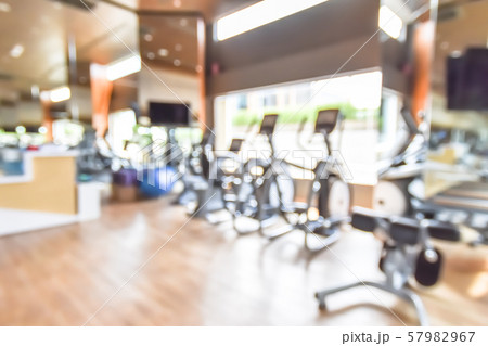Blur gym background fitness center or health club with blurry sports exercise equipment for aerobic workout and bodybuilding Blur gym background fitness center or health club with blurry sports exercise equipment for aerobic workout and bodybuilding 57982967