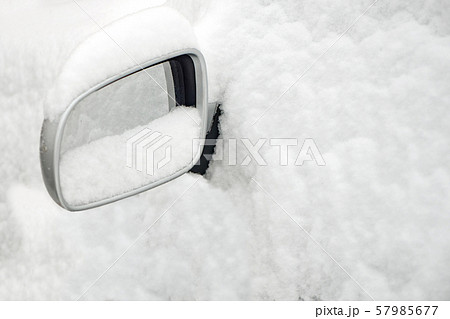 Car covered with snow. Car mirror sticking out of the snow. Winter season snow. Weather forecast 57985677