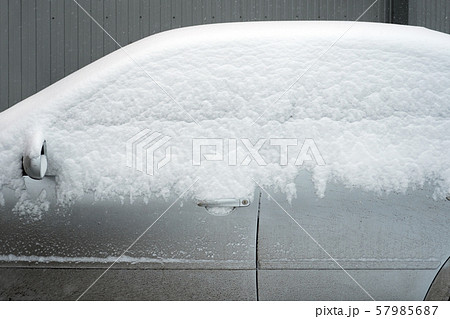 Poor visibility on the road. Car side view. Car under the snow. Automobile covered with white snow 57985687