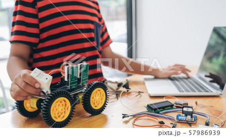 Boy with tablet pc computer programming electric 57986939