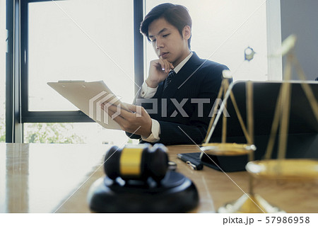 Male lawyer in the office with brass scale.. Male lawyer in the office with brass scale.. 57986958
