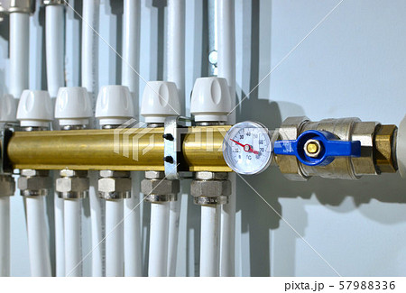 Close up of manometer, pipe, flow meter, water pumps and valves of heating system  57988336