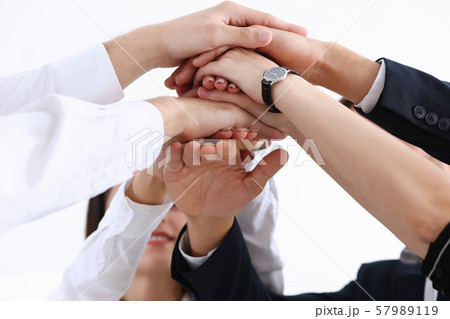 Group of people in suits crossed hands Group of people in suits crossed hands 57989119