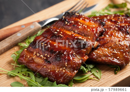 Closeup of pork ribs grilled with BBQ sauce. Closeup of pork ribs grilled with BBQ sauce. 57989661