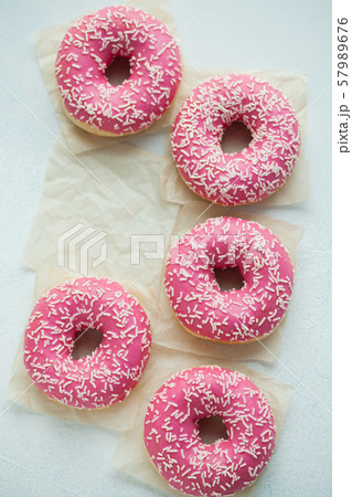 Pink doughnuts in icing sugar. 57989676