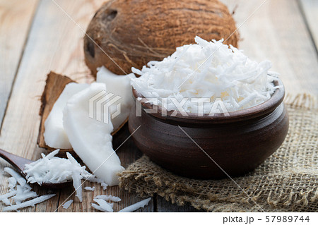Coconut flakes in a clay bowl. Coconut flakes in a clay bowl. 57989744