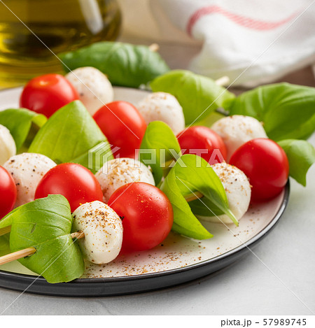 skewer with tomato, mozzarella and basil. 57989745
