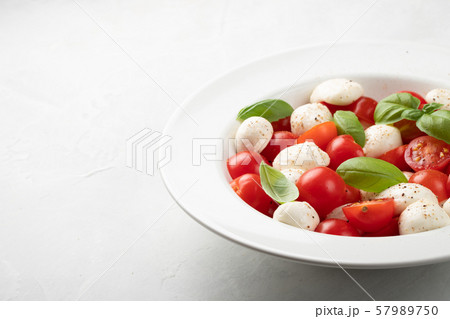 White plate of classic delicious caprese salad. White plate of classic delicious caprese salad. 57989750