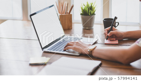 Close-up of female freelancer working on her Close-up of female freelancer working on her 57994141