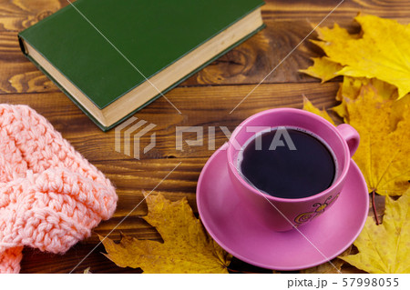 Cup of coffee, book, knitted scarf  57998055
