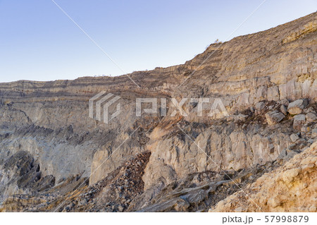 Rock cliff at Kawah Ijen volcano with turquoise 57998879