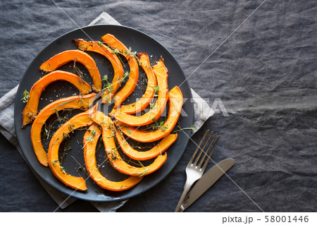 Roasted sliced pumpkin with thyme and salt. 58001446