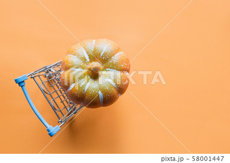 Grocery trolley with pumpkin on orange. Halloween Grocery trolley with pumpkin on orange. Halloween 58001447
