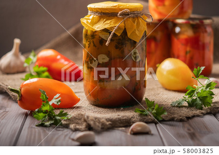 Homemade Jars of pickled peppers on a rustic wooden background. Pickled and preserved products. Next Homemade Jars of pickled peppers on a rustic wooden background. Pickled and preserved products. Next 58003825